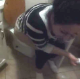 Some friends walk into a bathroom to video-record a brunette girl taking a shit. No audible pooping.